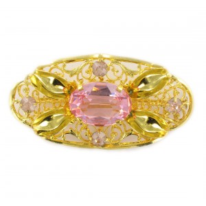 Oval perforated brooch with rose stones, gilded 54x28 mm