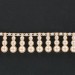 Banding with 3 plastic mother of pearl imitation beads pendant on cotton thread, cream 