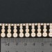 Banding with 3 plastic mother of pearl imitation beads pendant on cotton thread, cream 